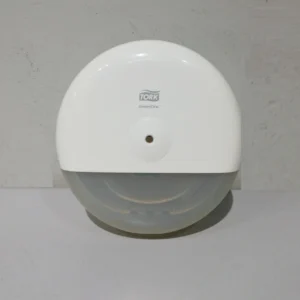 Dispensador de paper higiènic TORK fet de plàstic procedent d'un establiment en tancament